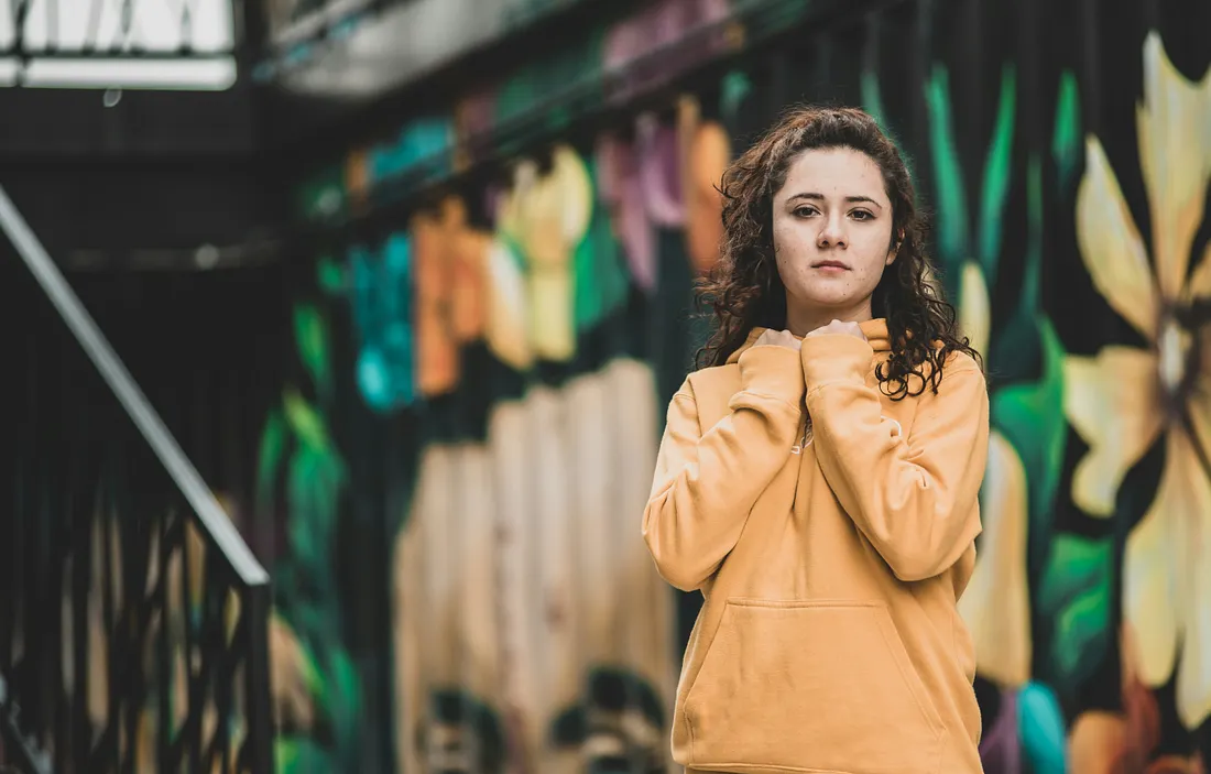 Girl standing in front of a mural
