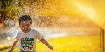 Boy having fun in a water splash