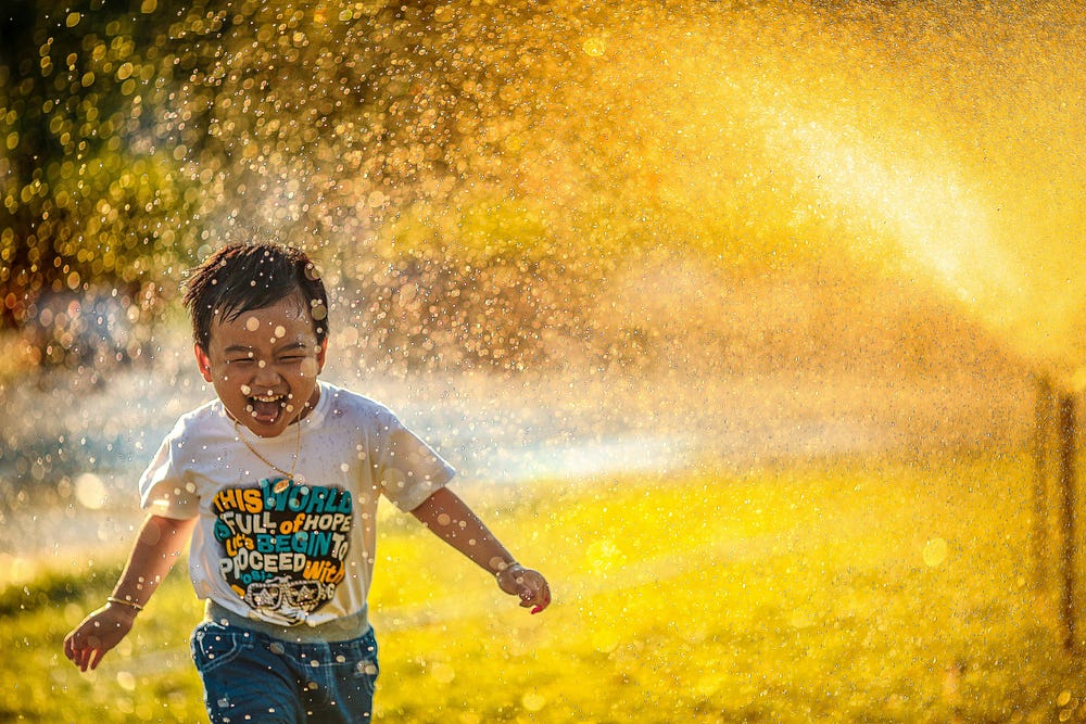 Boy having fun in a water splash