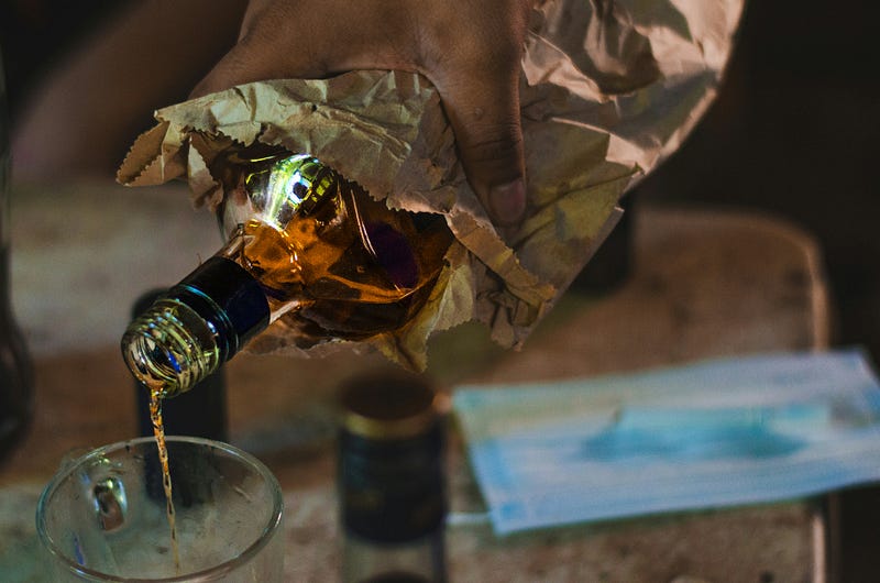 Bottle of alcohol wrapped in a paper bag
