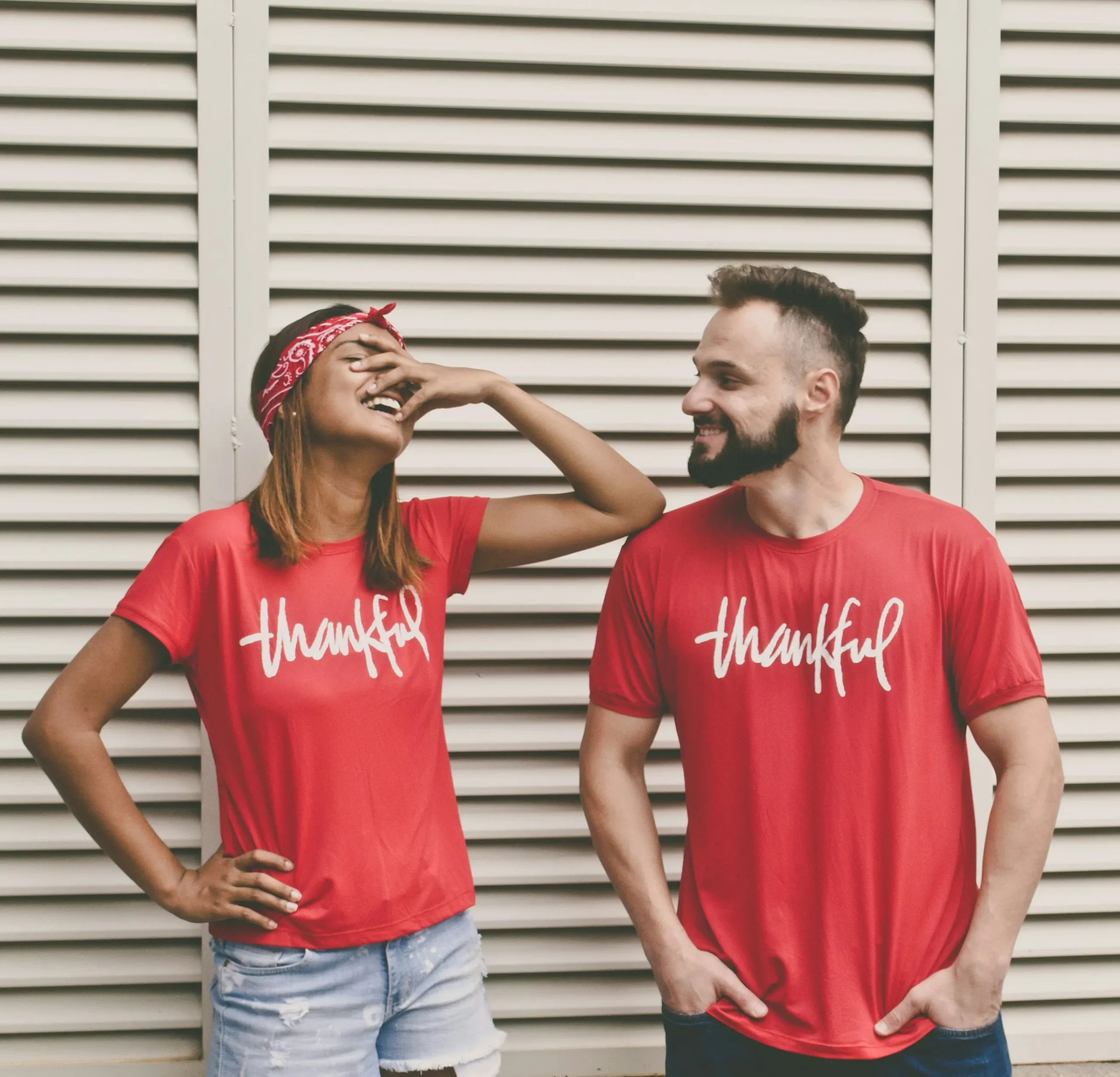 A man and a woman wearing a tshirt that says thankful. 
