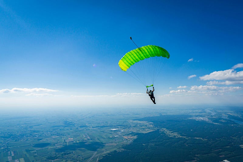 A person parachuting in the beautiful sky