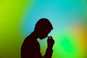 Boys thinking with a green and blue bright background