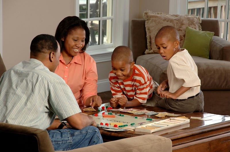 A family of four playing a board game 