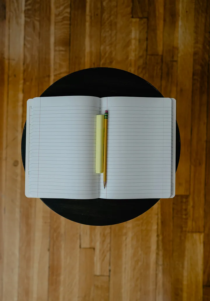 Empty notebook open with a pen inside